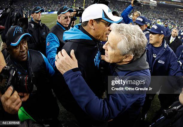 Head coach Pete Carroll of the Seattle Seahawks shakes hands with head coach Ron Rivera of the Carolina Panthers after their 2015 NFC Divisional...