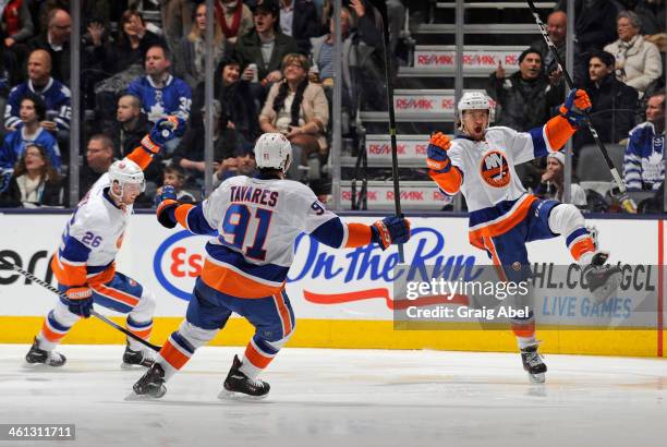 Thomas Vanek, John Tavares and Michael Grabner of the New York Islanders celebrate a second period goal during NHL game action against the Toronto...