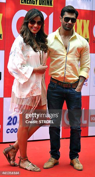 Indian Bollywood actors Bipasha Basu and Karan Singh pose for a photograph during the Celebrity Cricket League season five in Mumbai on January 10,...