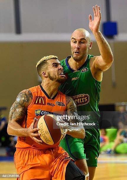 Scottie Wilbekin of the Taipans drives to the basket past Steven Markovic of the Crocodiles during the round 14 NBL match between the Townsville...