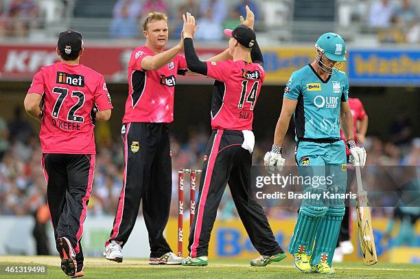 Doug Bollinger of the Sixers celebrates after taking thw wicket of Chris Lynn of the Heat during the Big Bash League match between the Brisbane Heat...
