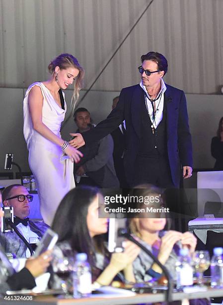 Honoree Amber Heard and actor Johnny Depp attend the 8th Annual HEAVEN Gala presented by Art of Elysium and Samsung Galaxy at Hangar 8 on January 10,...