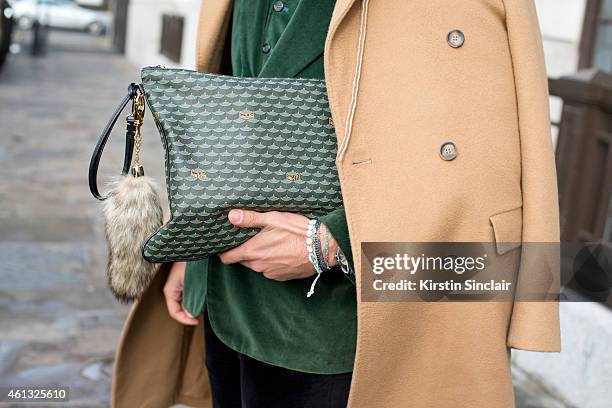 Fashion editor Kadu Dantas wearing a Margiella coat, Loja Vitor Alfaiate blazer and waistcoat, Zara trousers, Fauve le Page clutch bag on day 2 of...