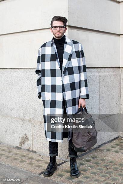 Musician Harry Hudson-Tailor wearing an Aggy and Sam jacket, Topman jeans, Doctor Martins boots, Cubitts glasses and an Ally Capolino bag on day 2 of...
