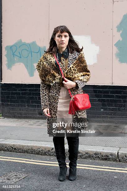 Shop owner and photographer Sara Reverberi wearing a Max Mara coat, Portamento boots, Gucci bag, Miu Miu skirt and vintage furs on day 2 of London...