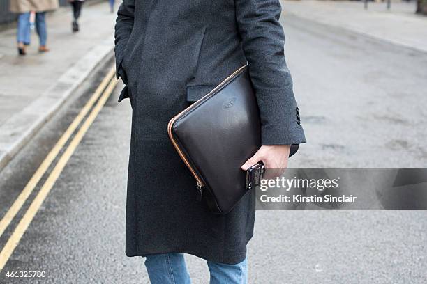 Senior editor for Leon magazine Hiroyuki Horikawa wearing Martin Margiela coat, Todds bag on day 2 of London Collections: Men on January 10, 2015 in...