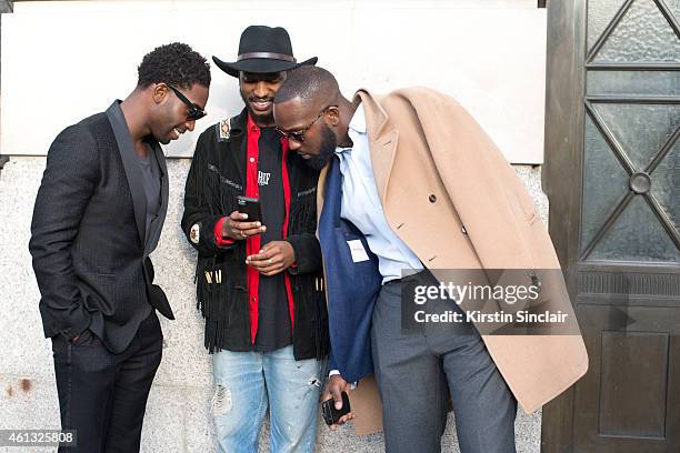 Pop singer Tinie Tempah wearing a Hardy Aimes suit with 2 guests on day 2 of London Collections: Men on January 10, 2015 in London, England.