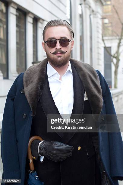 Fashion photographer Brad Green wearing a Reiss coat, Aston Martin blazer, Massimo Dutti gloves, Marks and Spencer shirt and Scarlett Soho sunglasses...