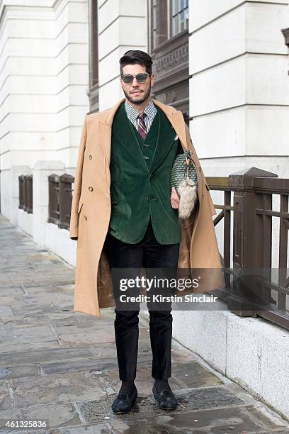 Fashion editor Kadu Dantas wearing a Margiella coat, Loja Vitor Alfaiate blazer and waistcoat, Zara trousers, Bluebird shoes, Fauve le Page clutch...