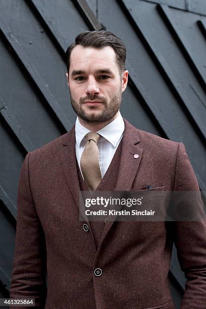 Presenter Stevie Kelly wearing a River Island suit, Emma Willis shirt and a vintage tie on day 2 of London Collections: Men on January 10, 2015 in...