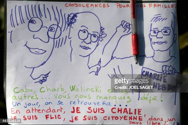 Sign with caricatures of some the journalists who were killed in the attack on the offices of Charlie Hebdo, the satirical magazine whose Paris...