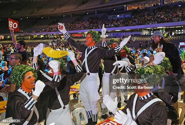 Spectators in fancy dress celebrate in the crowd during the Invitational Darts Challenge at Etihad Stadium on January 10, 2015 in Melbourne,...