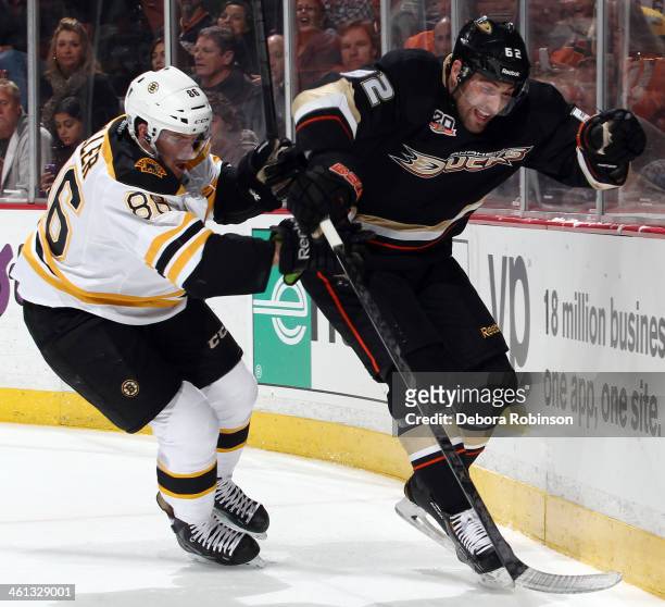 Patrick Maroon of the Anaheim Ducks battles for position against Kevan Miller of the Boston Bruins on January 7, 2014 at Honda Center in Anaheim,...