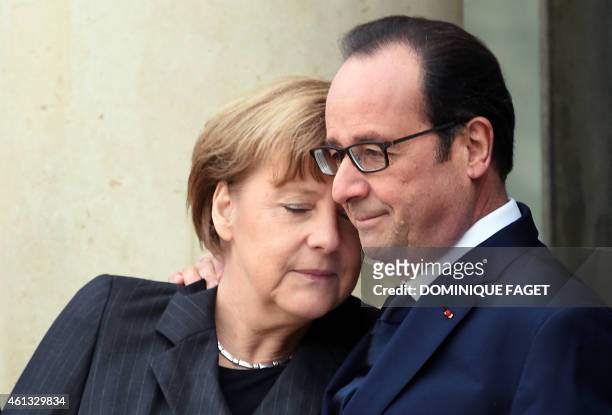 In this picture taken on January 11, 2015 French President Francois Hollande welcomes German Chancellor Angela Merkel at the Elysee Palace before...