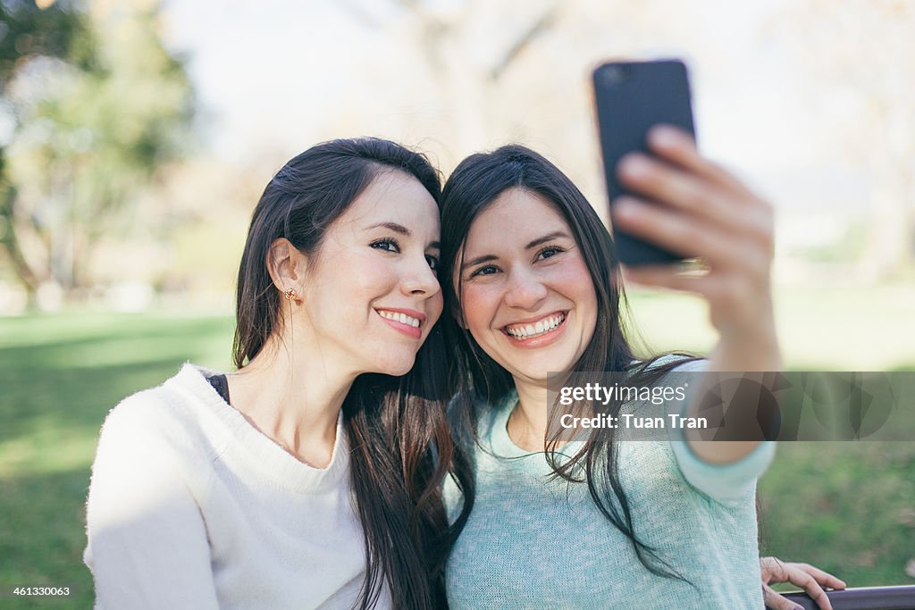 Woman taking self-portrait with their camera phone