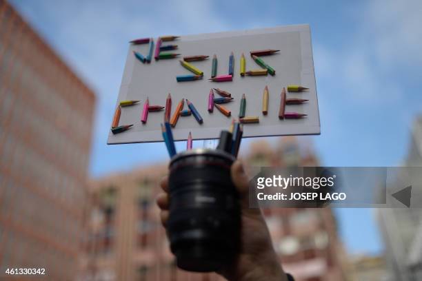 Man holds a placard made using pencils reading "I Am Charlie" during a show of solidarity outside the French Institute in Barcelona on January 11,...