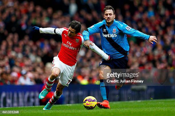 Tomas Rosicky of Arsenal battles for the ball with Marko Arnautovic of Stoke City during the Barclays Premier League match between Arsenal and Stoke...