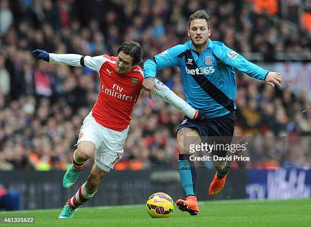 Tomas Rosicky of Arsenal is fouled by Marko Arnautovic of Stoke during the match between Arsenal and Stoke City in the Barclays Premier League at...