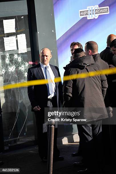 Israeli Economy Minister, Naftali Bennett pays his respects at the Hyper Cacher prior to a mass unity rally to be held in Paris following the recent...