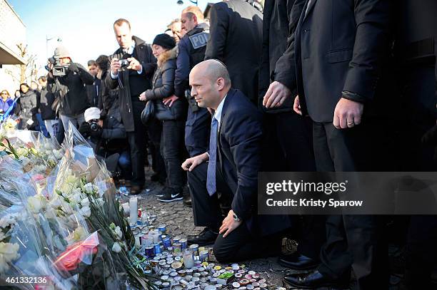 Israeli Economy Minister, Naftali Bennett pays his respects at the Hyper Cacher prior to a mass unity rally to be held in Paris following the recent...