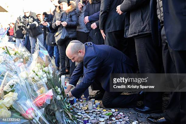 Israeli Economy Minister, Naftali Bennett pays his respects at the Hyper Cacher prior to a mass unity rally to be held in Paris following the recent...