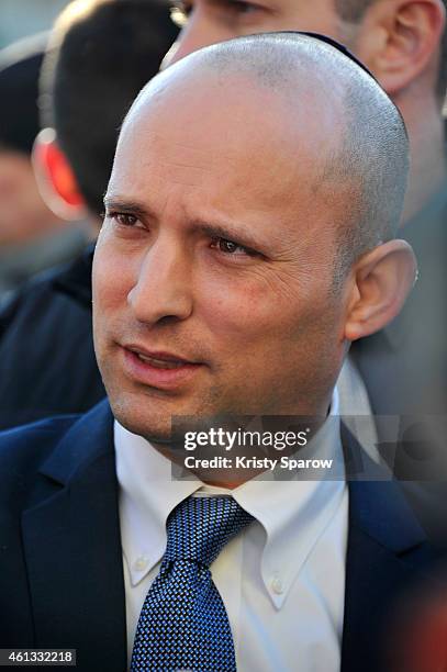 Israeli Economy Minister, Naftali Bennett pays his respects at the Hyper Cacher prior to a mass unity rally to be held in Paris following the recent...