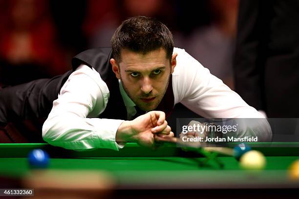 Mark Selby of England plays a shot during his first round match against Shaun Murphy of England on day one of the 2015 Dafabet Masters at Alexandra...