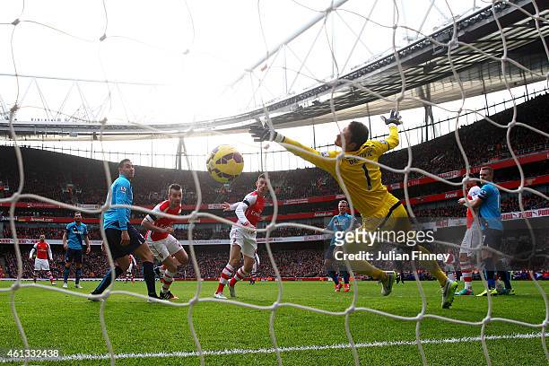Laurent Koscielny of Arsenal scores the opening goal past Asmir Begovic of Stoke City during the Barclays Premier League match between Arsenal and...