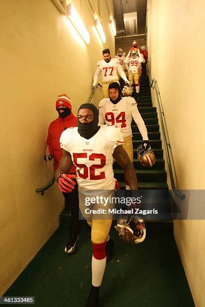 Patrick Willis, Justin Smith and Mike Iupati of the San Francisco 49ers head to the field prior to the game against the Green Bay Packers at Lambeau...