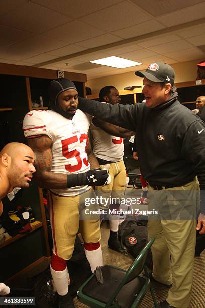 Head Coach Jim Harbaugh of the San Francisco 49ers celebrates with NaVorro Bowman in the locker room following the game against the Green Bay Packers...