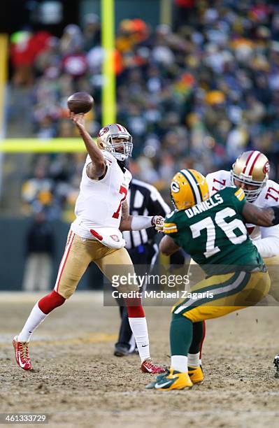 Colin Kaepernick of the San Francisco 49ers passes as Mike Iupati blocks during the game against the Green Bay Packers at Lambeau Field on January 5,...