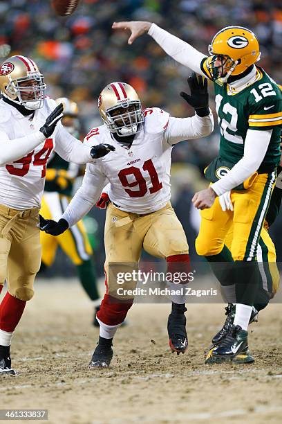 Ray McDonald and Justin Smith of the San Francisco 49ers pressures Aaron Rodgers of the Green Bay Packers during the game at Lambeau Field on January...