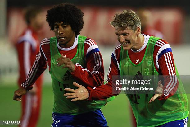 Bastian Schweinsteiger and Dante react during day 3 of the Bayern Muenchen training camp at ASPIRE Academy for Sports Excellence on January 11, 2015...