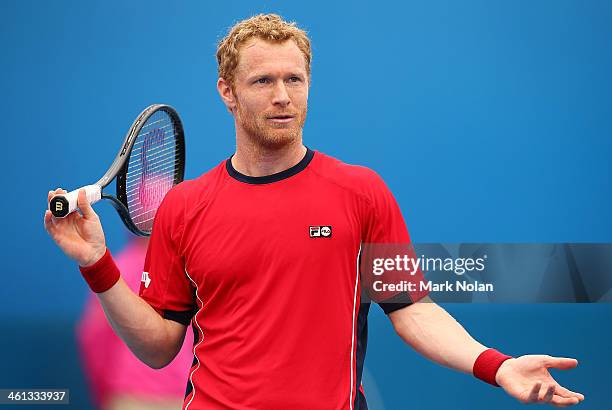 Dmitry Tursunov of Russia disputes a call in his match against Lukas Rosol of the Czech Republic during day four of the 2014 Sydney International at...