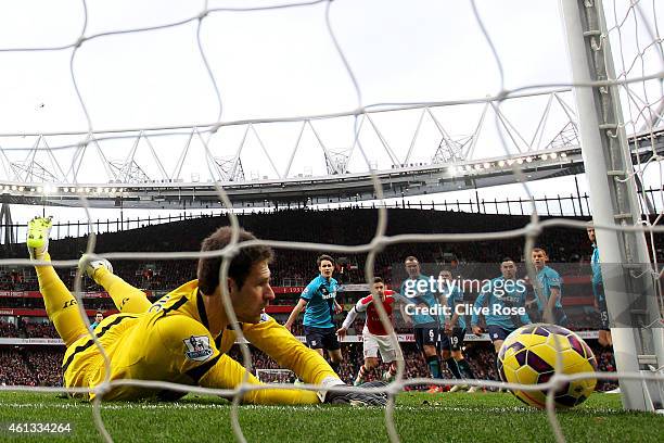 Asmir Begovic of Stoke City fails to stop the ball crossing the line as Alexis Sanchez of Arsenal scores his team's third goal from a freekick during...