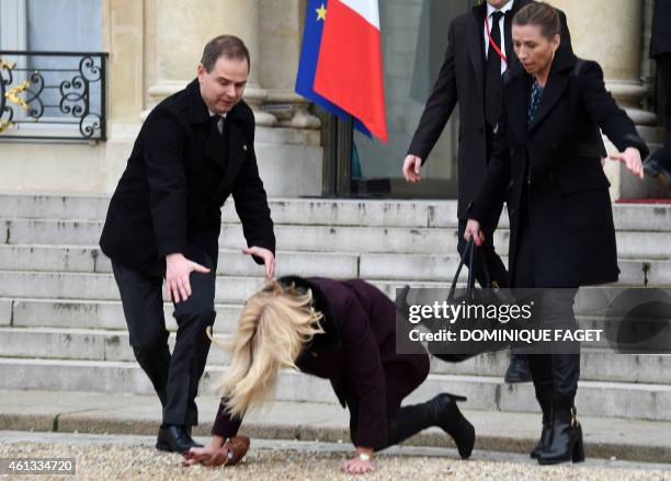 Danish Prime Minister Helle Thorning-Schmidt falls down as she leaves the Elysee Palace after attending a Unity rally "Marche Republicaine" on...