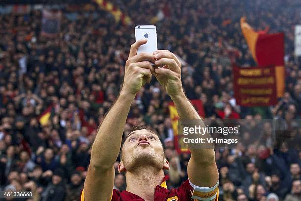 Francesco Totti of AS Roma selfie Apple iPhone during the Serie A match between AS Roma and Lazio Roma on January 11,2014 at the Stadio Olimpico in...