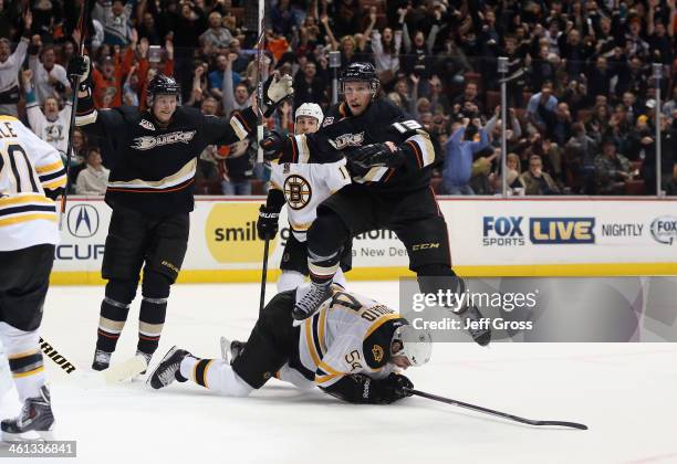 Nick Bonino of the Anaheim Ducks leaps over Adam McQuaid of the Boston Bruins after scoring a goal, as Corey Perry of the Ducks celebrates in the...