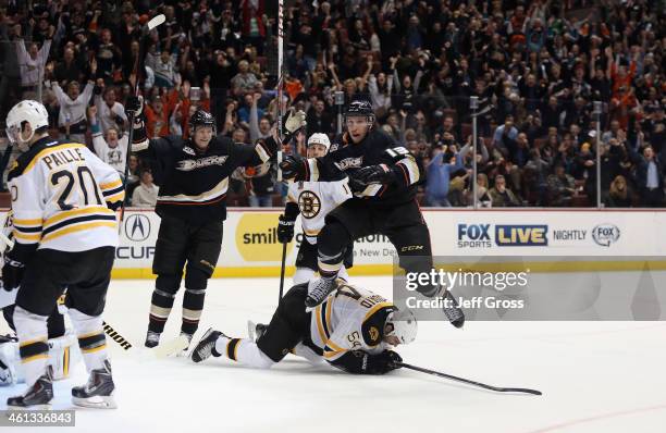 Nick Bonino of the Anaheim Ducks leaps over Adam McQuaid of the Boston Bruins after scoring a goal, as Corey Perry of the Ducks celebrates in the...