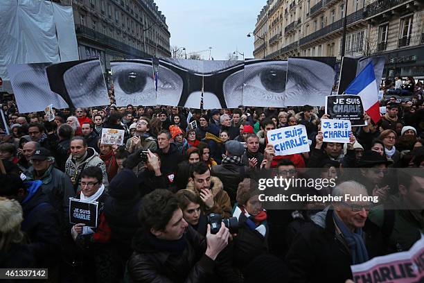 Demonstrators make their way along Boulevard Voltaire in a unity rally in Paris following the recent terrorist attacks on January 11, 2015 in Paris,...