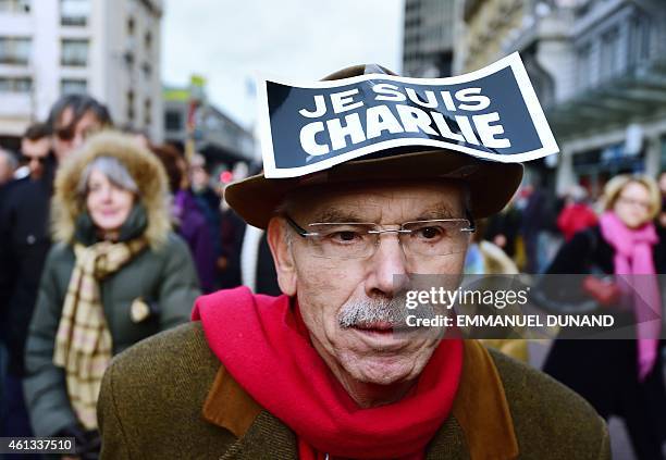 Some 20,000 people march on January 11, 2015 in Brussels, some holding placards, reading: "Je suis Charlie" , in tribute to the 17 victims of the...