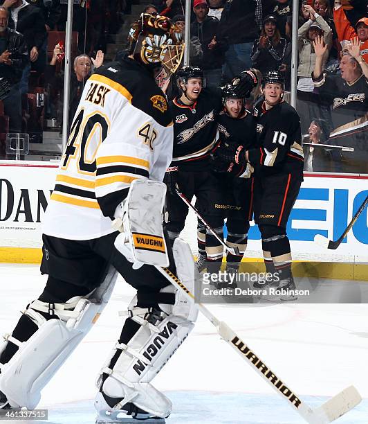 Hampus Lindholm, Mathieu Perreault and Corey Perry of the Anaheim Ducks celebrate Perreault's third-period goal against Tuukka Rask of the Boston...