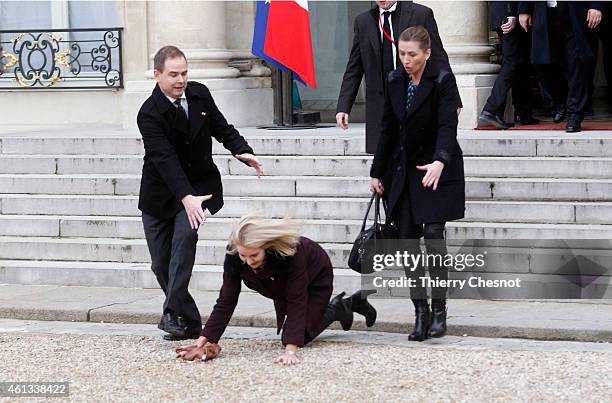 Danish Prime Minister Helle Thorning-Schmidt falls down as she leaves the Elysee Palace after attending a Unity rally on January 11, 2015 in Paris,...