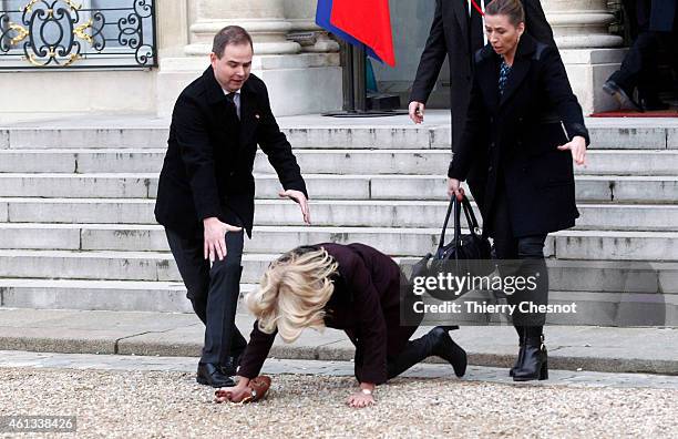 Danish Prime Minister Helle Thorning-Schmidt falls down as she leaves the Elysee Palace after attending a Unity rally on January 11, 2015 in Paris,...