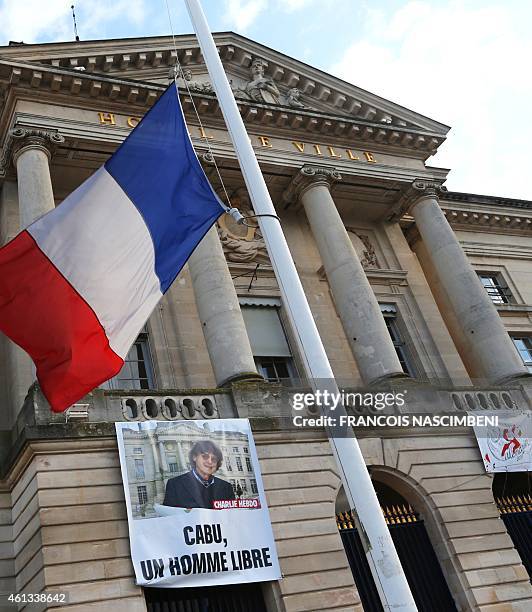 Photo of French satirical cartoonist Cabu is posted outside the Chalons-en-Champagne city hall, his home town, on January 11 in tribute of the 17...