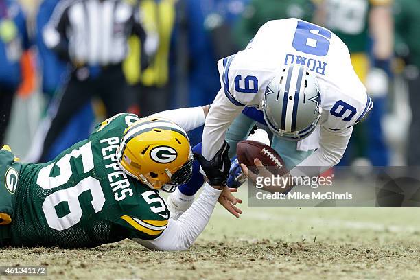 Tony Romo of the Dallas Cowboys recovers his fumble against Julius Peppers of the Green Bay Packers during the 2015 NFC Divisional Playoff game at...