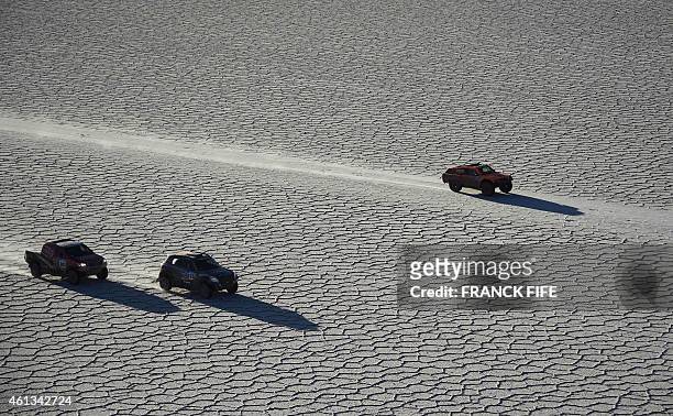 Toyota's driver Giniel De Villiers of South Africa and co-driver Dirk Von Zitzewitz of Germany , Mini's driver Vladimir Vasilyev and co-driver...