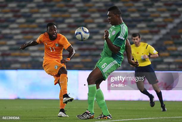 Ivory Coast's Tallo Gadji kicks the ball past Nigeria's Azubuike Egwuekwe during an international friendly football match in preparation for the...