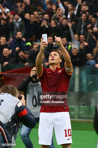 Francesco Totti of AS Roma takes a selfie after scoring a goal during the Serie A match between AS Roma and Lazio on January 11,2014 at the Stadio...