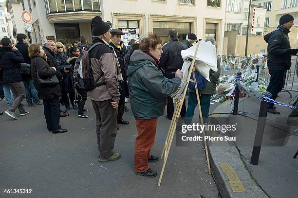 People show their respect for the victims near the Charlie Hebdo offices following the recent terrorist attacks on January 11, 2015 in Paris, France....